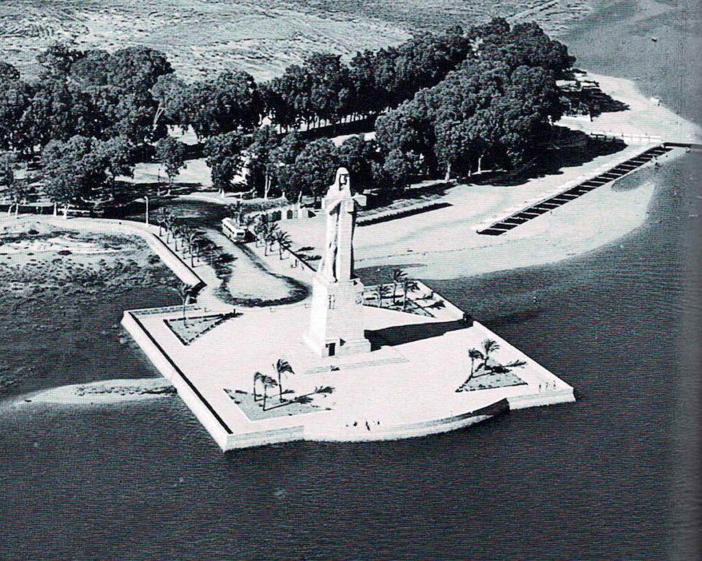 Vista completa del monumento y su entorno con la hilera de toldos en la playa. 1960.